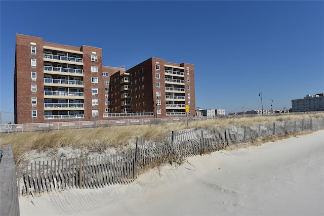 view of building exterior featuring fence