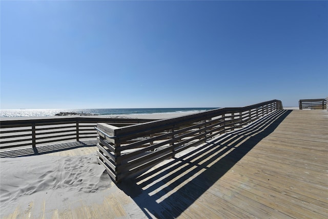 wooden terrace with a water view and a beach view