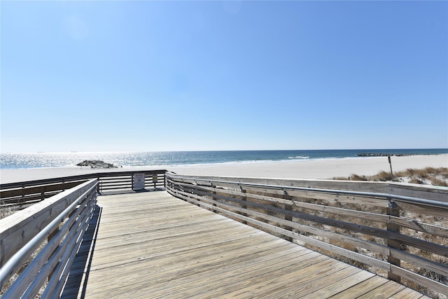 view of community with a beach view and a water view