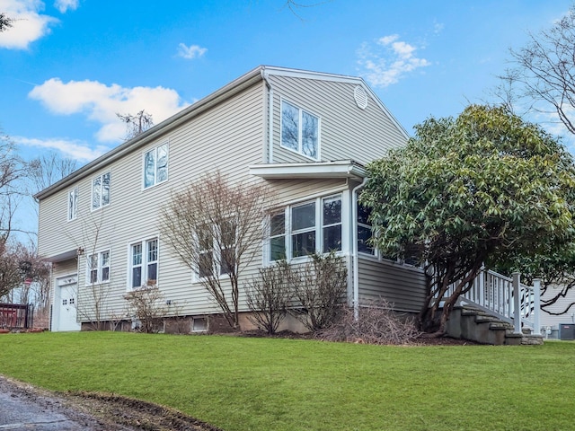 view of side of home featuring a lawn