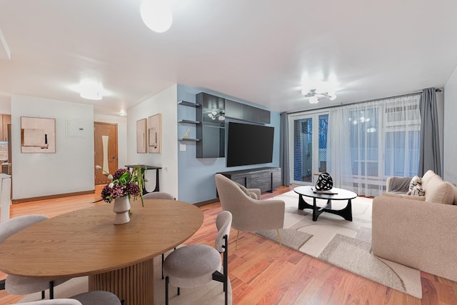 living area featuring light wood-type flooring and baseboards