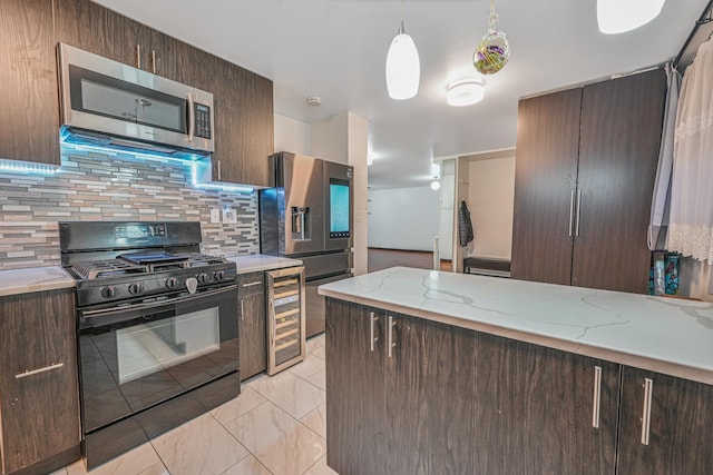 kitchen with dark brown cabinetry, beverage cooler, appliances with stainless steel finishes, backsplash, and light stone countertops