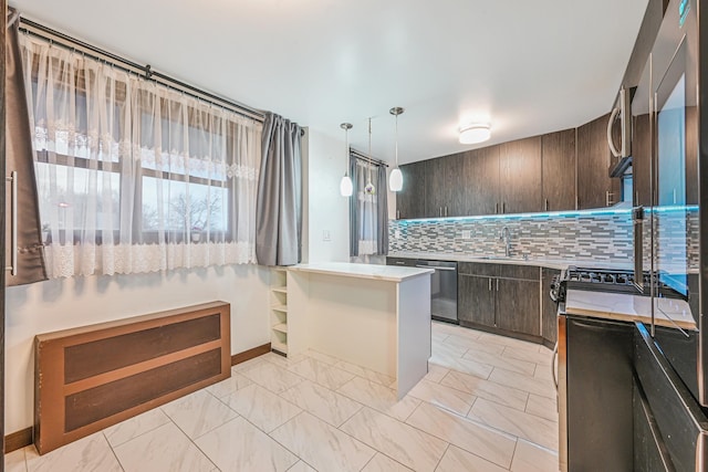 kitchen featuring stainless steel appliances, a sink, marble finish floor, dark brown cabinets, and tasteful backsplash