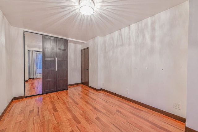 unfurnished bedroom featuring baseboards and wood finished floors