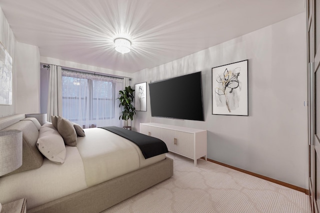 bedroom featuring light colored carpet and baseboards