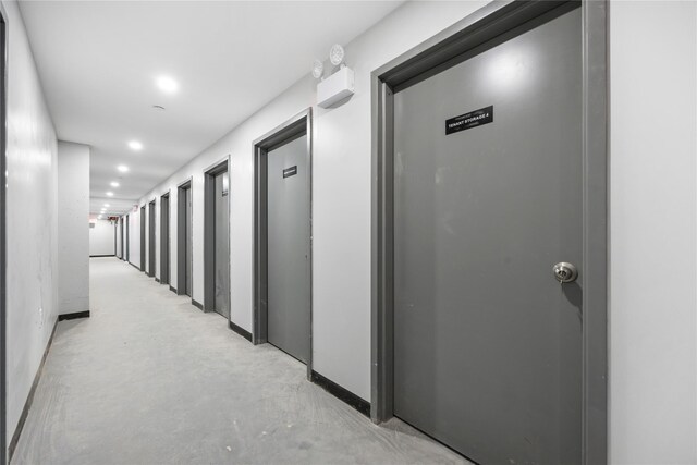 163-07 72nd Ave Unit 2A, Fresh Meadows, NY 11365 - hallway featuring concrete floors, baseboards, and recessed lighting