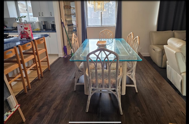 dining area featuring dark wood finished floors and baseboards