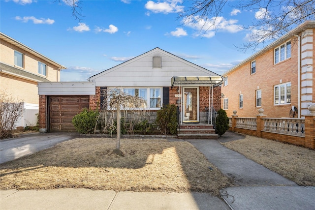 view of front of property with a garage, brick siding, and driveway