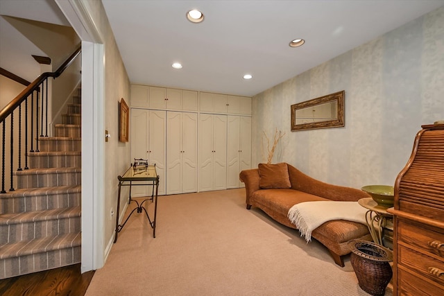 living area with carpet, stairway, and recessed lighting