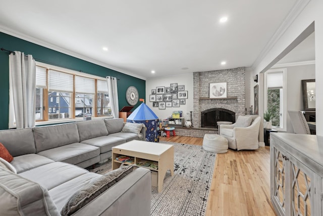 living area featuring plenty of natural light, a fireplace, and light wood-style floors