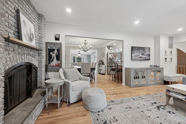 living area featuring recessed lighting, ornamental molding, a fireplace, and wood finished floors