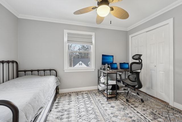 bedroom with a closet, a ceiling fan, crown molding, and baseboards