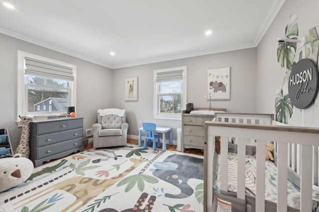 bedroom featuring multiple windows, wood finished floors, baseboards, and ornamental molding