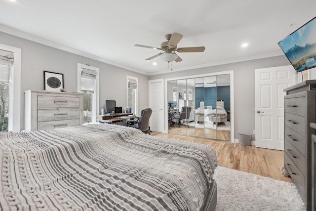 bedroom with light wood-type flooring, multiple windows, and ornamental molding