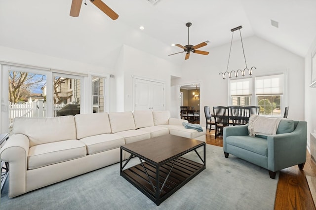 living area featuring ceiling fan, high vaulted ceiling, plenty of natural light, and wood finished floors