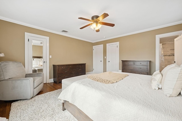 bedroom featuring ceiling fan, wood finished floors, visible vents, baseboards, and crown molding