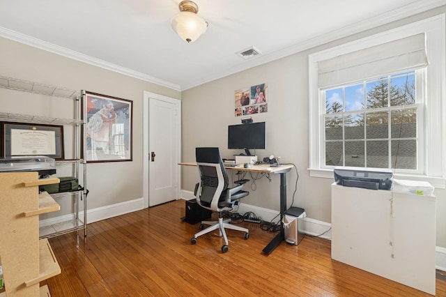 office area with wood-type flooring, visible vents, and crown molding