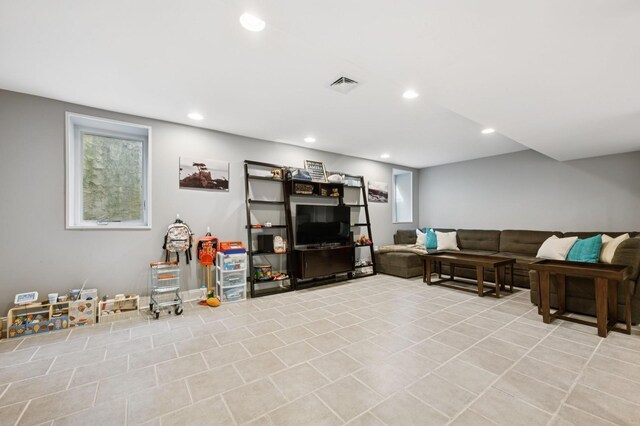 living room with recessed lighting, visible vents, and light tile patterned floors