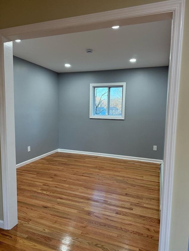 unfurnished room with recessed lighting, baseboards, and wood finished floors