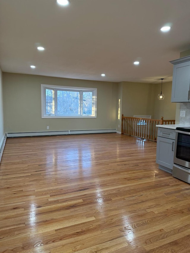 interior space with recessed lighting, light wood-style floors, stainless steel electric stove, and gray cabinetry