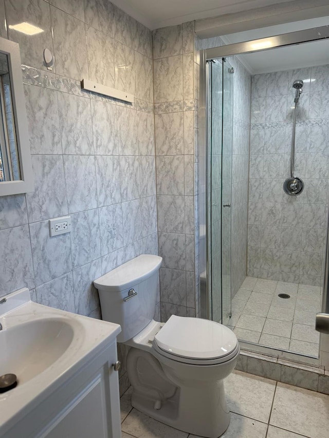 full bath featuring tile patterned flooring, a shower stall, toilet, and vanity