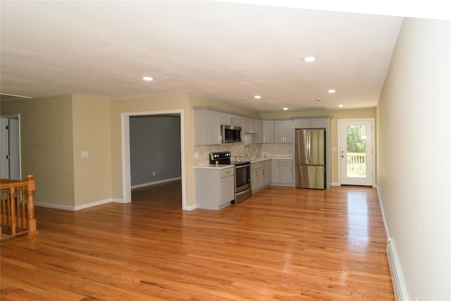 30 Bushwick Ave, Brentwood, NY 11717 - kitchen with stainless steel appliances, gray cabinetry, light countertops, tasteful backsplash, and recessed lighting