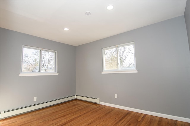 30 Bushwick Ave, Brentwood, NY 11717 - unfurnished room featuring healthy amount of natural light, wood finished floors, recessed lighting, a baseboard radiator, and baseboards