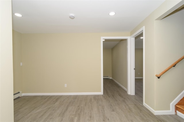 30 Bushwick Ave, Brentwood, NY 11717 - empty room with a baseboard radiator, light wood-type flooring, recessed lighting, baseboards, and stairs