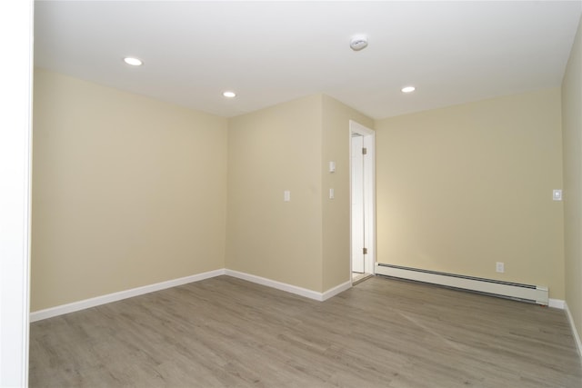 30 Bushwick Ave, Brentwood, NY 11717 - unfurnished room with a baseboard radiator, light wood-style floors, recessed lighting, baseboards, and a smoke detector