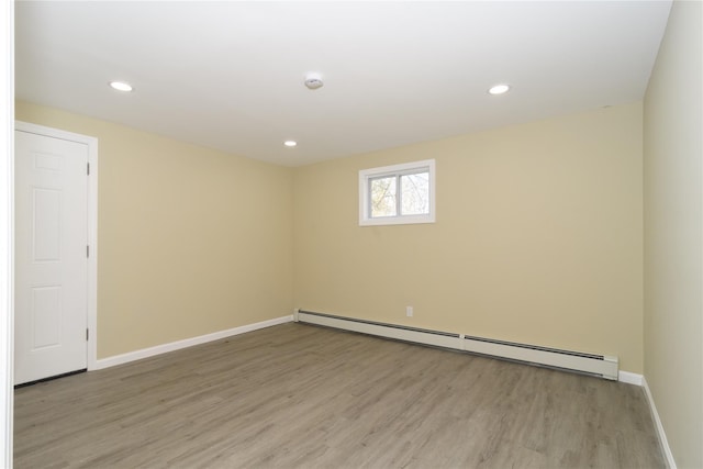 30 Bushwick Ave, Brentwood, NY 11717 - spare room with a baseboard radiator, light wood finished floors, baseboards, and recessed lighting