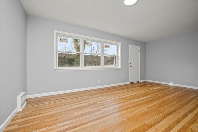 unfurnished room with baseboards, visible vents, and light wood-style floors