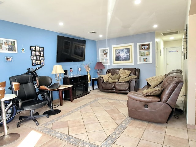 living room with light tile patterned flooring, built in features, visible vents, and recessed lighting