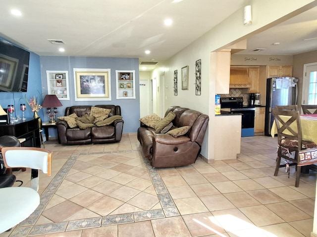 living room with recessed lighting, visible vents, and light tile patterned flooring