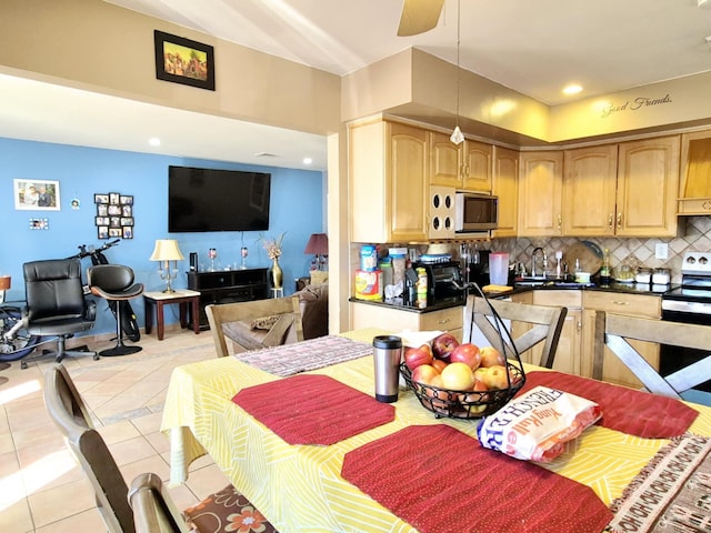 kitchen with electric range, decorative backsplash, a ceiling fan, pendant lighting, and light tile patterned flooring