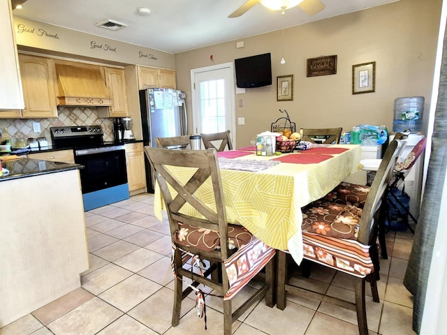 dining area with light tile patterned floors, ceiling fan, and visible vents