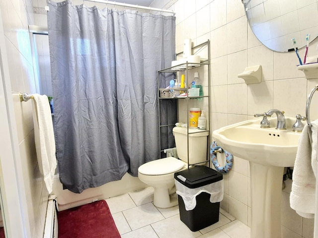 bathroom with tile walls, toilet, a baseboard radiator, tile patterned flooring, and backsplash