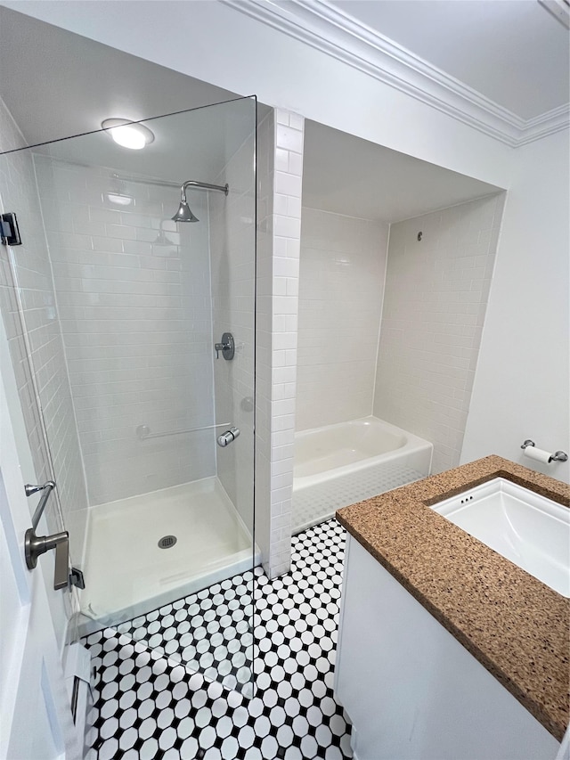 full bath featuring ornamental molding, a tile shower, and vanity