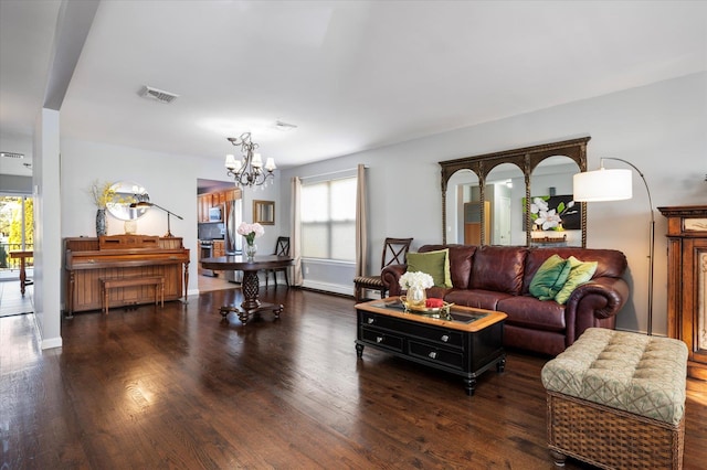 living area featuring an inviting chandelier, plenty of natural light, wood finished floors, and visible vents