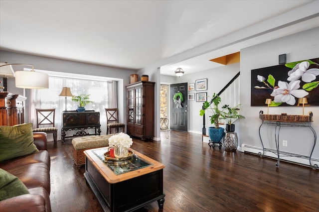 living area with baseboard heating, stairs, baseboards, and wood finished floors