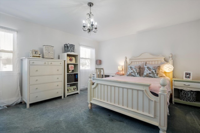 bedroom featuring a notable chandelier and dark carpet