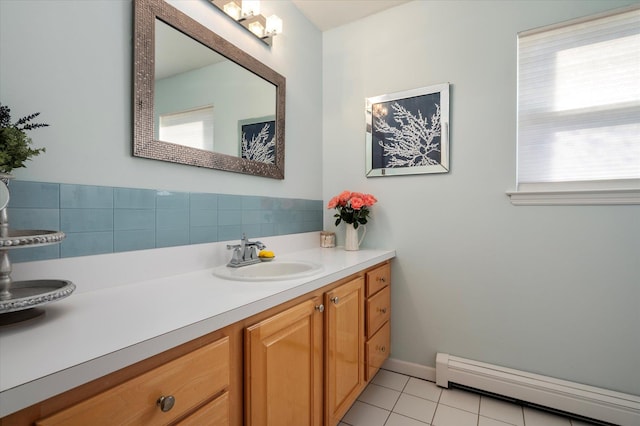 bathroom with tile patterned flooring, vanity, baseboards, and a baseboard radiator