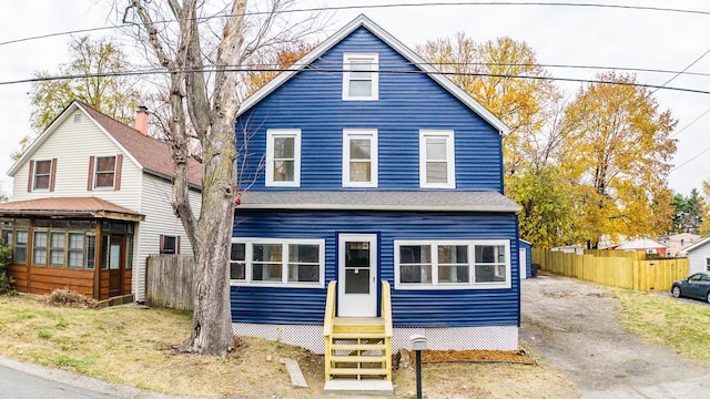 view of front of home featuring entry steps and fence