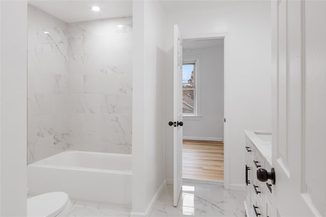 bathroom featuring toilet, marble finish floor, baseboards, and vanity