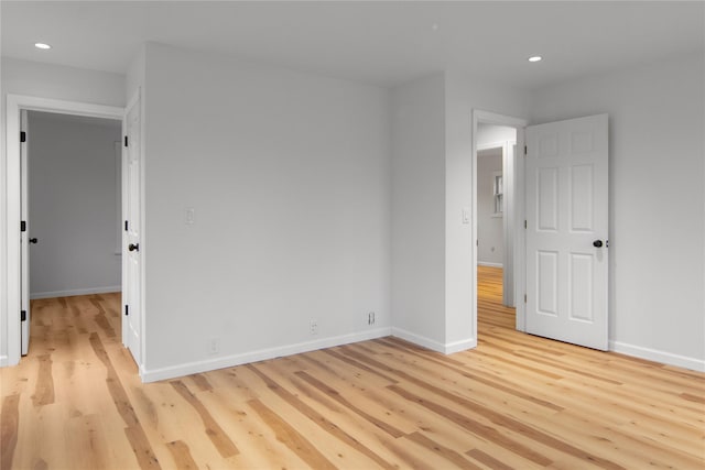 unfurnished bedroom featuring light wood finished floors, baseboards, and recessed lighting