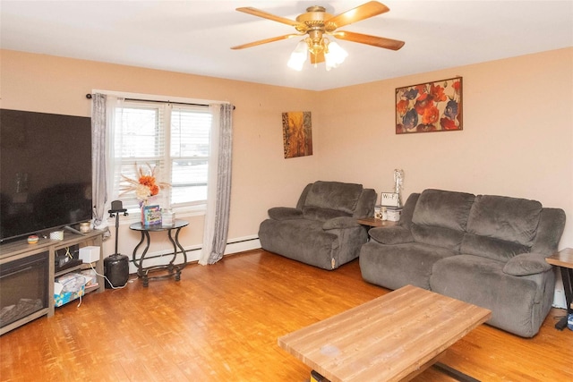 living area featuring a baseboard radiator, ceiling fan, and wood finished floors