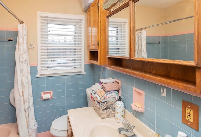 full bath with a shower with shower curtain, vanity, toilet, and tile walls