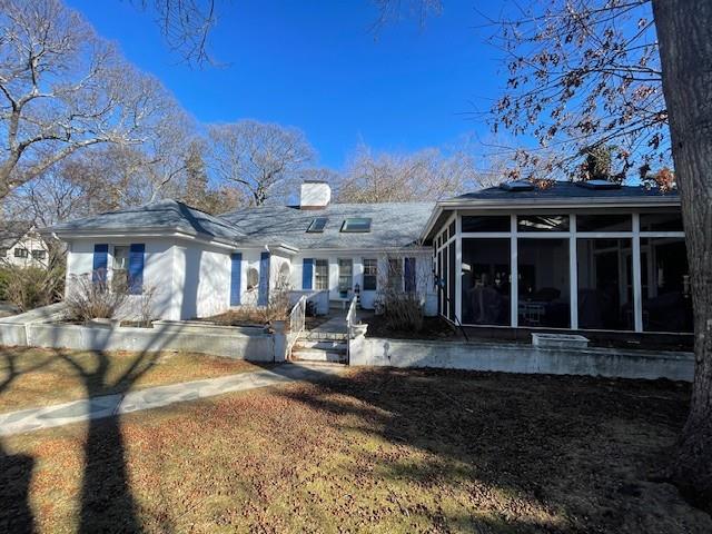 view of front facade with a sunroom