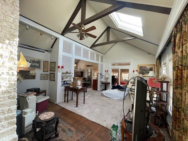 interior space with ceiling fan and vaulted ceiling with skylight