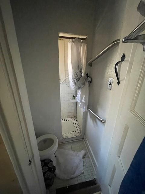 full bath with a stall shower and toilet