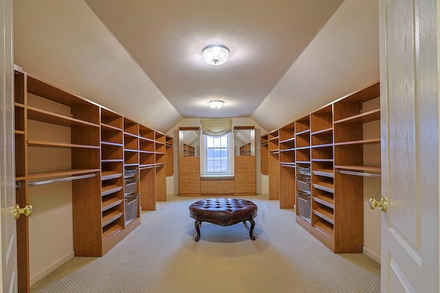 spacious closet with carpet floors and vaulted ceiling